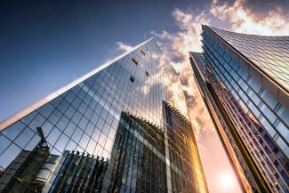 High rise glass buildings with clouds
