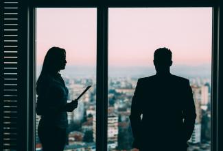 Two people in office silhouette
